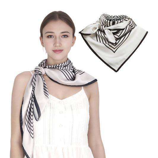 Woman wearing a black and white patterned scarf with an inset showing the scarf folded.