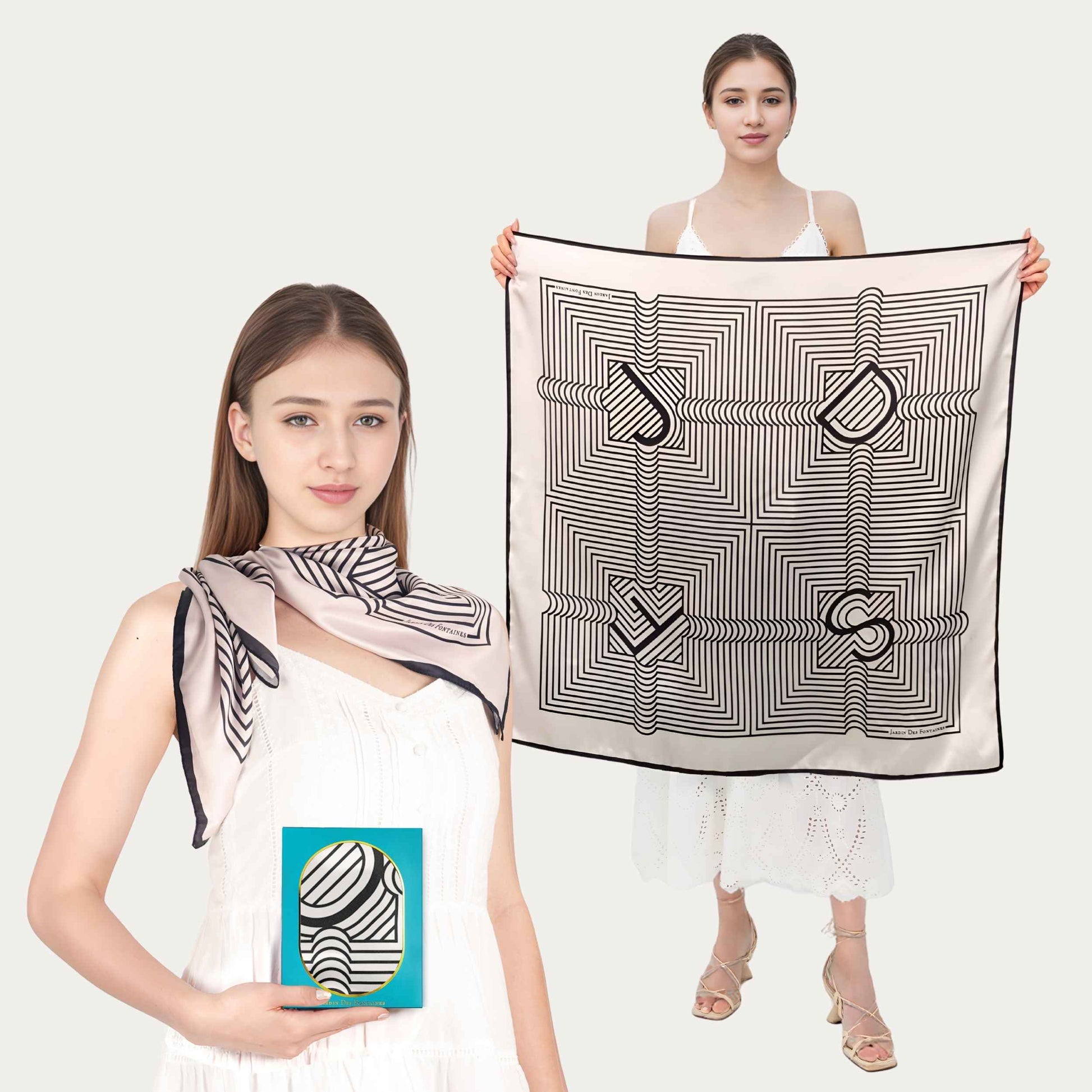 Two women holding black and white patterned scarves against a white background