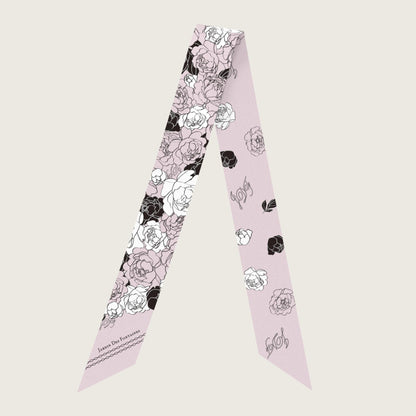 Floral patterned scarf on a light pink background
