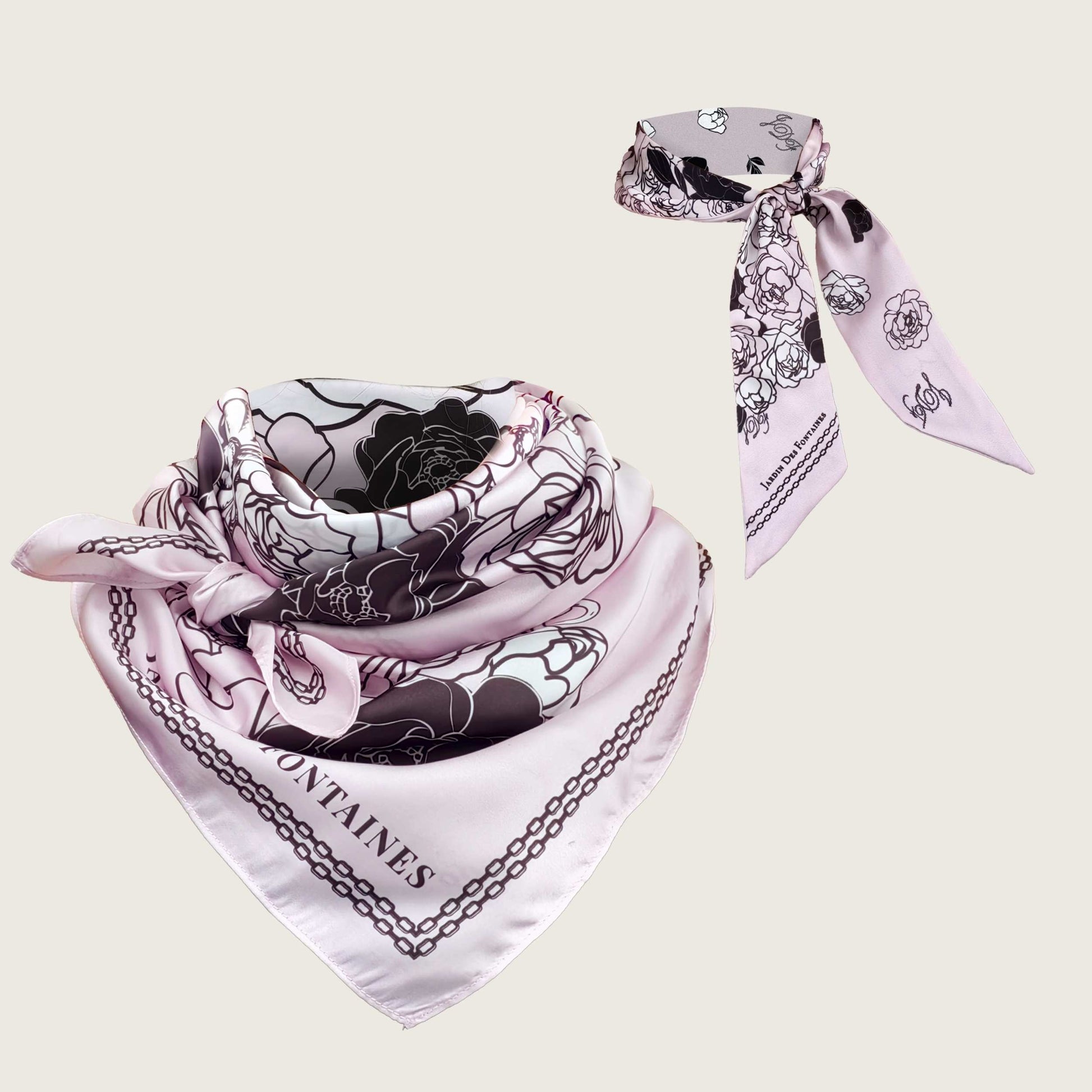 White scarf with black floral design and 'Montaines' branding on a light beige background